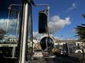 A 2017 Freightliner M Line with side mirrors reflecting the surroundings