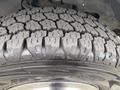 Close-up of a treaded tire showcasing a detailed pattern and rubber texture designed for traction on a 2014 Chevrolet Express