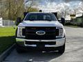 A front view of a 2018 Ford F-550 truck with a black grille and chrome bumper featuring the Ford logo prominently in the center
