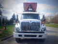 A 2016 International WorkStar 7500 truck with a large container on the back and a prominent front grille showcasing the brand's logo