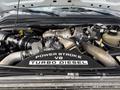 A 2008 Ford F-450 SD engine with visible components including a turbocharger and a large black Power Stroke V8 Turbo Diesel label