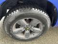 Close-up of a black alloy wheel with a rugged tire on a 2019 RAM 1500 Classic showcasing its design and tread pattern