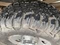 Close-up view of a rugged tire from a 2005 Ford F-350 SD with deep treads and visible wear indicating off-road use