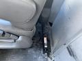 A 2023 GMC Savana seat base with a visible jack mechanism attached to the floor near the seat
