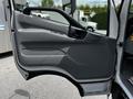 A gray door of a 2018 Hino 195 truck is open showing the interior handle and panel design