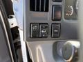 Control panel of a 2013 Isuzu NPR showing various buttons for lights and settings