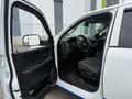 A 2016 RAM 1500 with an open driver's door showcasing the interior features including the steering wheel and dashboard