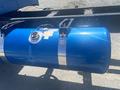 A blue fuel tank mounted on a 2008 Peterbilt 340 with a silver strap and a fuel cap on top