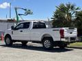 A white 2020 Ford F-350 Super Duty truck with four-wheel drive parked on a concrete surface