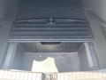 The trunk of a 2017 Acura TLX featuring a black storage compartment cover above an empty storage area