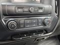 Dashboard controls and climate settings of a 2018 Chevrolet Silverado 1500 including buttons for audio and air conditioning