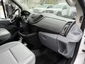 Interior view of a 2019 Ford Transit showing the dashboard and front seats with gray upholstery and a central control panel