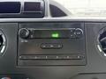 Dashboard controls of a 2019 Ford Econoline featuring audio system buttons a digital display and air conditioning vents