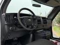 Interior of a 2015 Chevrolet Express with a steering wheel dashboard controls and center console visible