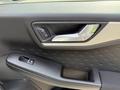 Close-up of the door handle and window controls of a 2020 Ford Escape featuring a sleek design and modern finish