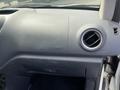 Dashboard of a 2010 Ford Transit Connect featuring an airbag indicator and a round air vent on the right