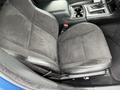 A black fabric front seat of a 2022 Dodge Charger with a center console featuring cup holders and gear shift