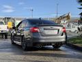 A gray 2021 Subaru WRX featuring a sporty design with a rear spoiler and dual exhaust pipes