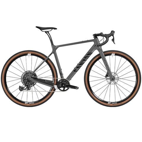 A 2025 Canyon Grizl CF SL 8 Eagle Road Bike featuring a sleek gray frame wide tires and distinctive orange accents designed for durability and performance