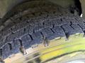 Close-up of a worn tire tread from a 1994 Volvo FE 42 showcasing deep grooves and visible cracks on the rubber surface