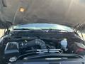 The engine compartment of a 2011 RAM 1500 showing the engine, air intake system, and various components including a coolant reservoir and hoses