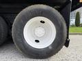 A close-up of a Goodyear G622 tire mounted on a white rim showing treads and wheel bolts