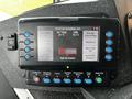 A control panel featuring a digital display with buttons for various functions including headlights, engine status, and system controls for a 2009 Spartan Gladiator