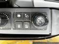 Control panel of a 2024 Caterpillar 306 featuring various buttons and a dial for operating functions