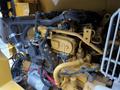 Close-up of the engine components of a 2024 Caterpillar 306 featuring yellow and black pipes wires gauges and connectors