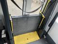 A lift mechanism with yellow-platforming and a mesh barrier designed for accessibility in a 2017 Chevrolet Express van