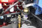 A 2015 Kenworth T660 engine compartment showing various components including a fuel filter a coolant reservoir and several hoses and valves