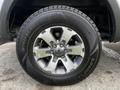 A close-up of a shiny silver alloy wheel with six spokes and a Goodyear Winter Command tire on a 2014 Ford F-150