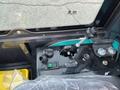 Control panel of a 2024 AGT Industrial Green QH13R Mini Excavator featuring joysticks switches and dials for operation