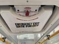 The ceiling hatch of a 2017 Chevrolet Express with a labeled emergency exit and instructions for opening displayed in both English and French