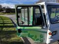 A 2019 CanEV Might-E Truck with a partially open door featuring green leaf designs and a charging symbol on the driver's side