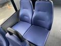 A pair of blue textured seats designed for passenger transport in a 2017 Chevrolet Express van