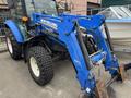 A blue 2016 New Holland T475 tractor with a front loader attachment and large tires