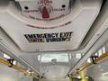 A ceiling view of a 2017 Chevrolet Express showing an emergency exit sign with instructions in English and French