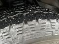 Close-up of the tire tread of a 2009 Ford Econoline showing deep grooves and textured surface designed for traction and grip