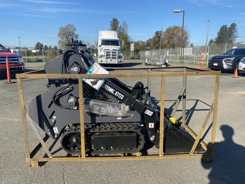 A 2024 AGT KTT23 compact tracked loader in a metal shipping crate with a black exterior and tracks designed for maneuverability and heavy lifting