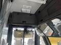 Interior view of a 2007 Freightliner B2 featuring a ceiling-mounted storage compartment and a front windshield with a fan mounted below