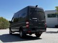 A 2017 Mercedes-Benz Sprinter van with a sleek design and dark exterior parked with the rear and side visible