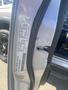 A silver 2021 RAM 1500 door frame with a vehicle identification number sticker affixed to it showing various details and specifications of the truck