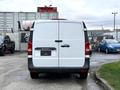 A white 2020 Mercedes-Benz Metris van viewed from the rear with a split door design and a missing license plate