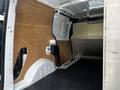 Interior of a 2014 Ford Transit Connect with wood paneling on the sides and black textured flooring