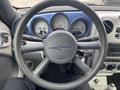 Interior view of a 2007 Chrysler PT Cruiser showing the steering wheel dashboard and instrument cluster with gauges for speed fuel and temperature