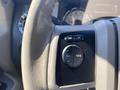 Close-up of the steering wheel controls in a 2013 Ford Expedition featuring buttons for setting cruise control and adjusting its settings