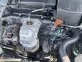 A close-up view of the engine compartment of a 2017 Acura TLX featuring various components including the exhaust manifold and connecting hoses