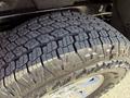 Close-up of a tire with deep tread patterns mounted on a 2018 GMC Canyon showcasing durability and grip designed for various driving conditions