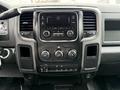 The interior dashboard of a 2013 RAM 3500 featuring a central touchscreen display with audio controls and climate controls below the screen